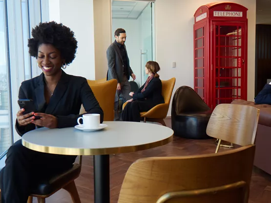 Modern coworking area with city views—ideal for informal meetings, networking, or working on the go with coffee in hand.