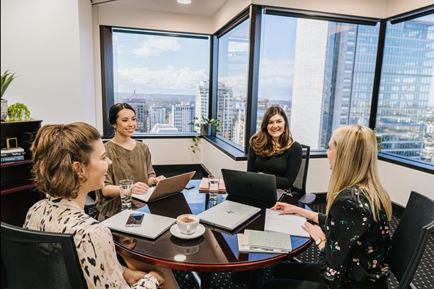 A team of professionals using a meeting room for collaboration.